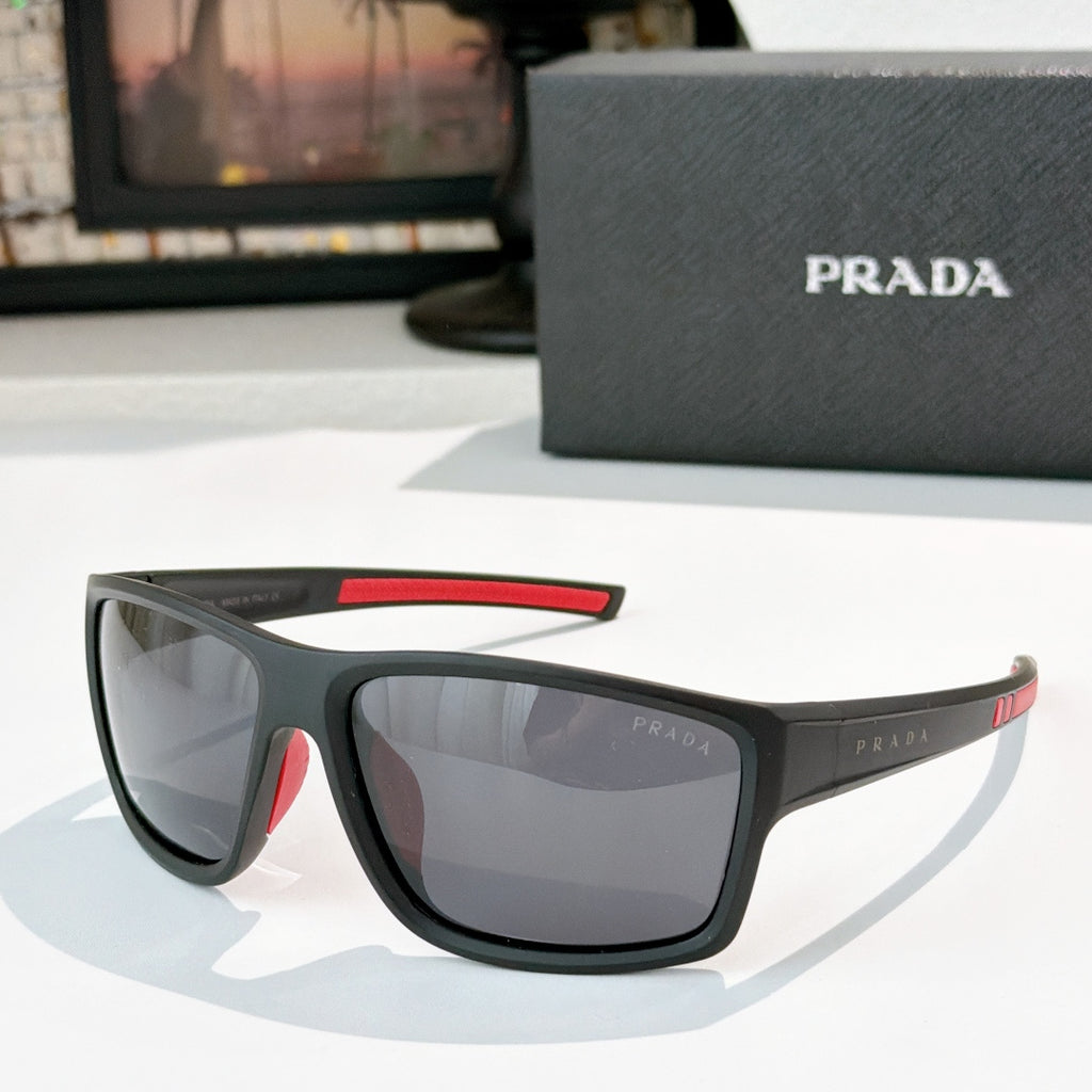 Prada sunglasses with black frame, red accent on upper arm, tinted lenses
