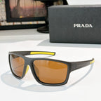 Prada sunglasses with dark frame, yellow accent bar, amber tinted lenses