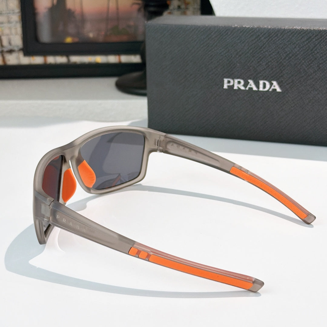 Prada sunglasses side view with beige frame, orange accents, tinted lenses