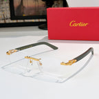 Cartier eyeglasses with clear lenses and gold frame accents, dark green temple arms