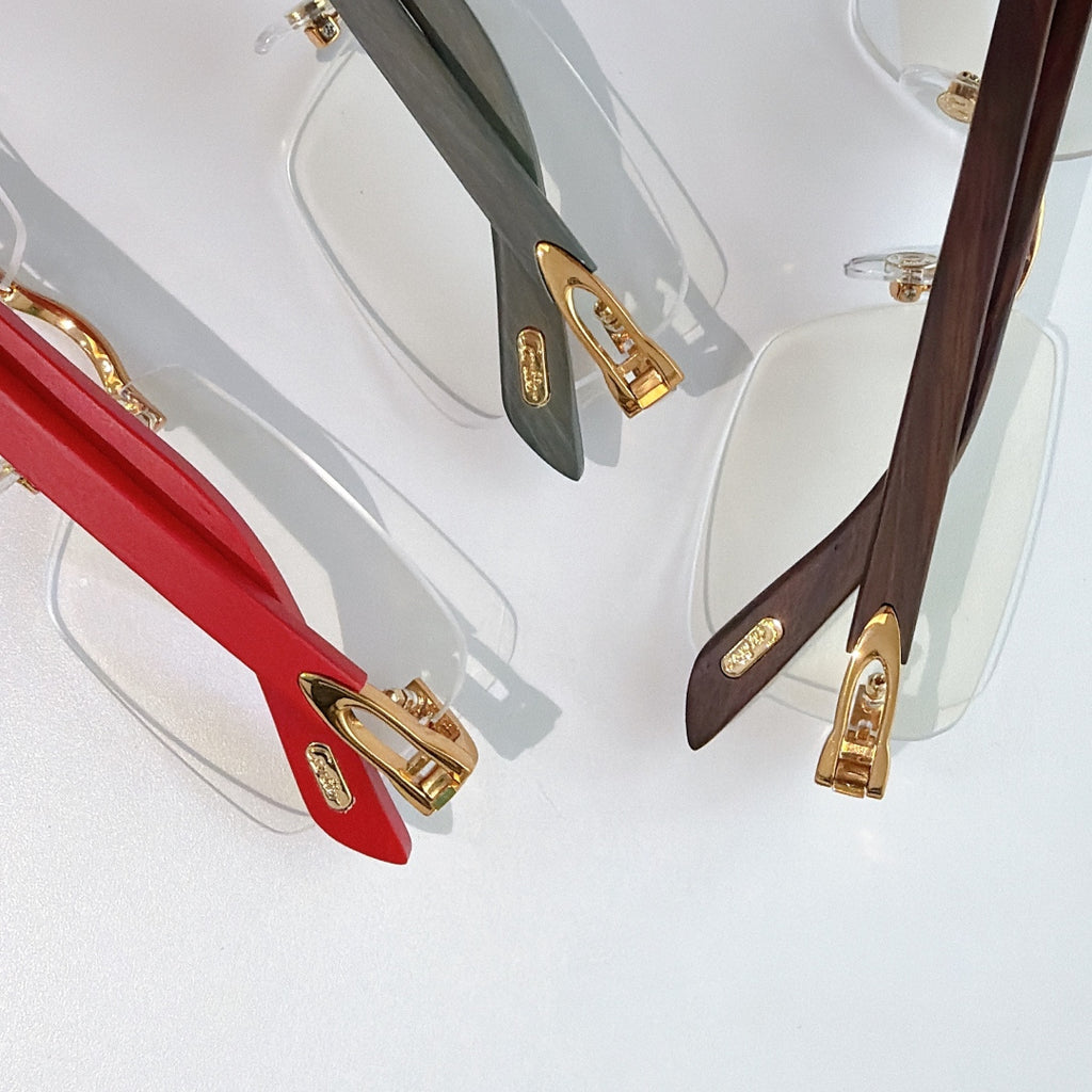 Cartier eyeglasses detail view: red, dark green, and brown temples with gold hinges