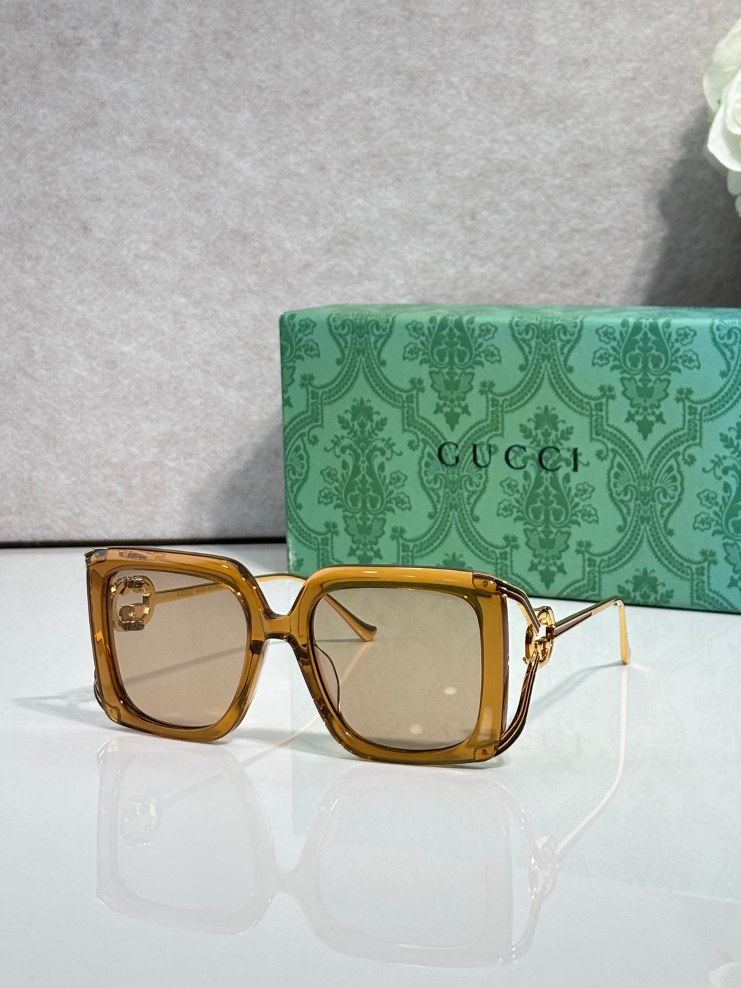 Gucci square sunglasses with tan tortoise frame and clear tinted lenses