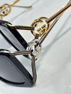 Gucci sunglasses close-up: gold and silver hardware detail on the temple