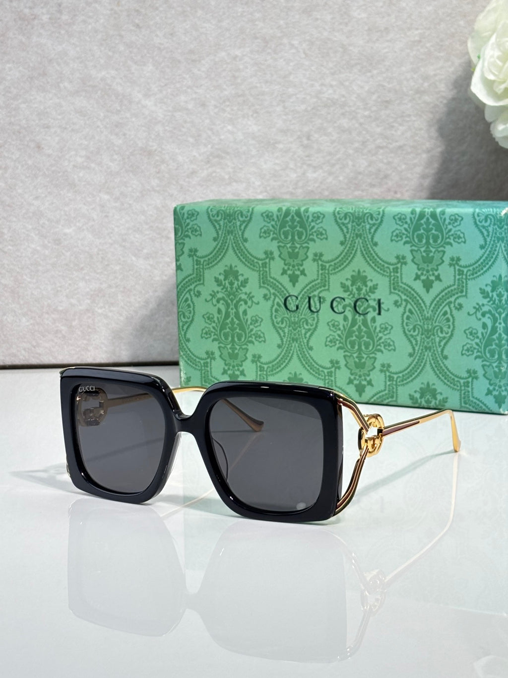 Gucci square sunglasses with black frame and dark gray lenses