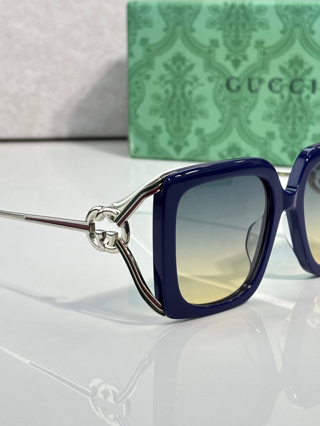 Gucci square sunglasses with blue frame and gradient lenses, side view