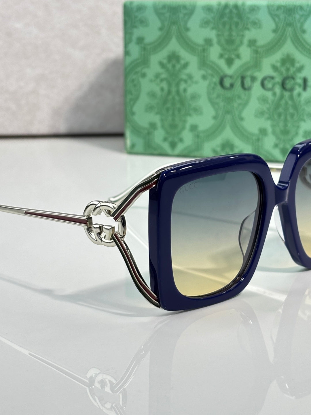 Gucci square sunglasses with blue frame and gradient lenses, side view