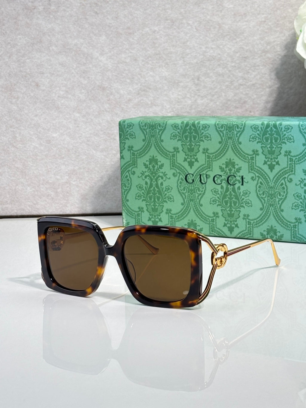 Gucci square sunglasses with dark tortoise frame and warm brown lenses