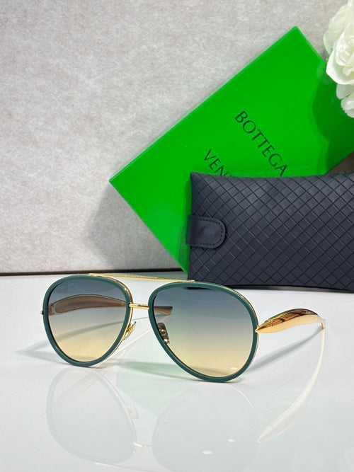Bottega Veneta sunglasses with dark teal frames and reflective amber lenses