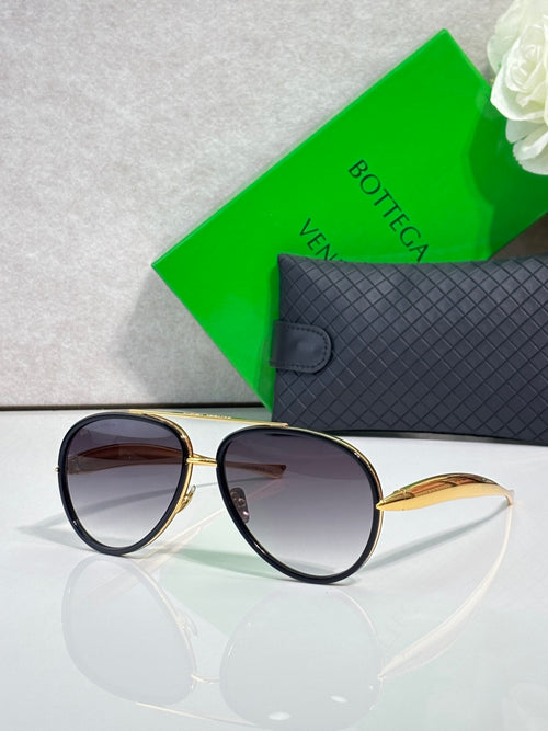 Bottega Veneta oval sunglasses with dark lenses and gold-tone round frame