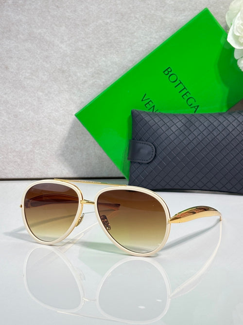 Bottega Veneta sunglasses with gold frames and brown gradient lenses