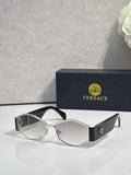 Sunglasses with light silver frame, dark lenses, gold logo detail on temple