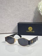 Sunglasses with gold frame, dark lenses, blue temple with gold logo detail