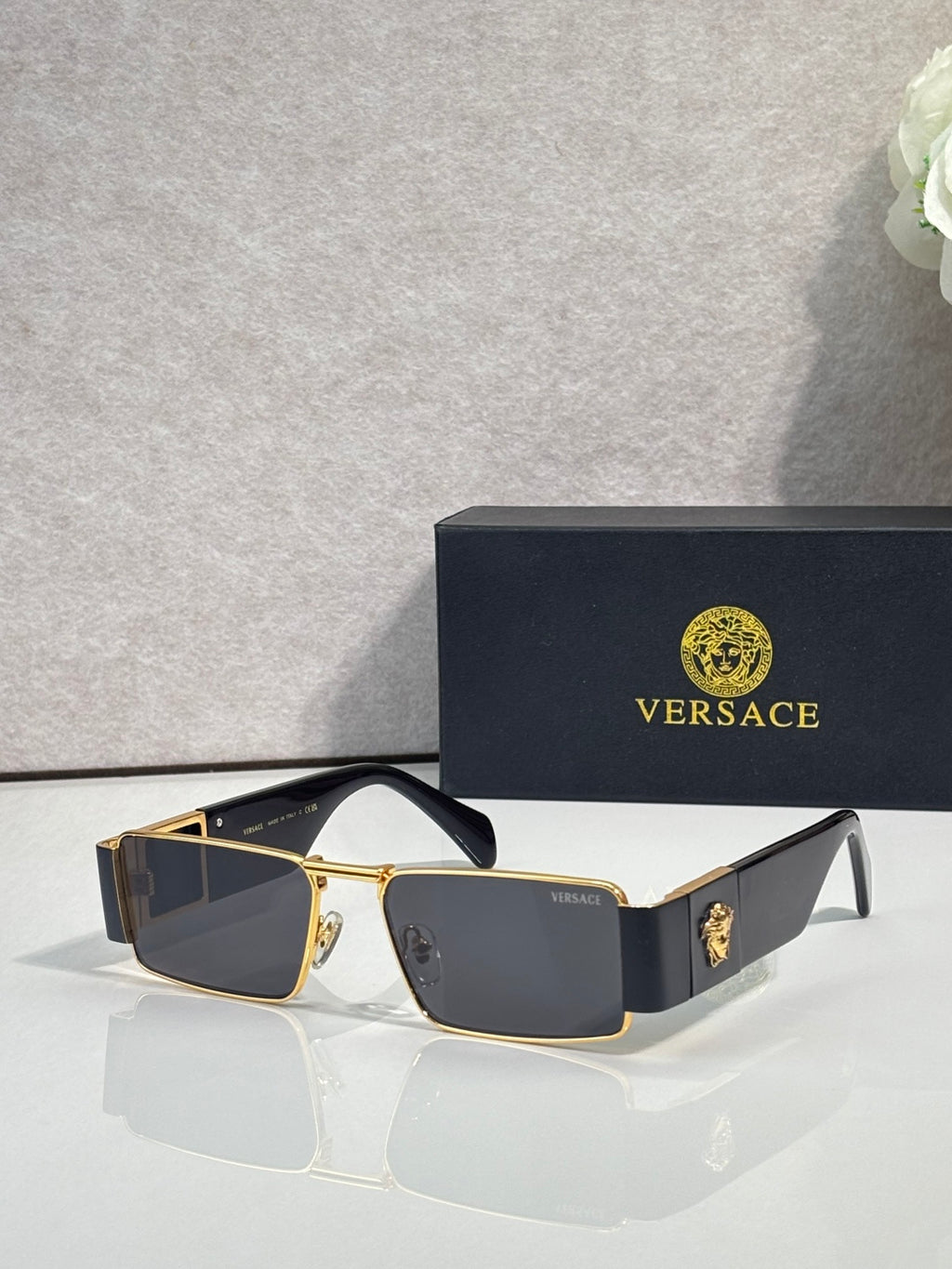 Versace rectangular sunglasses with gold-tone frame and dark blue lenses, tortoiseshell side panels