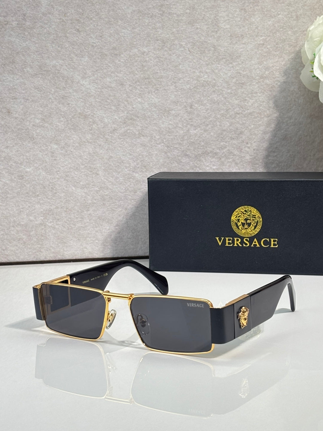 Versace rectangular sunglasses with gold-tone frame and dark blue lenses, tortoiseshell side panels