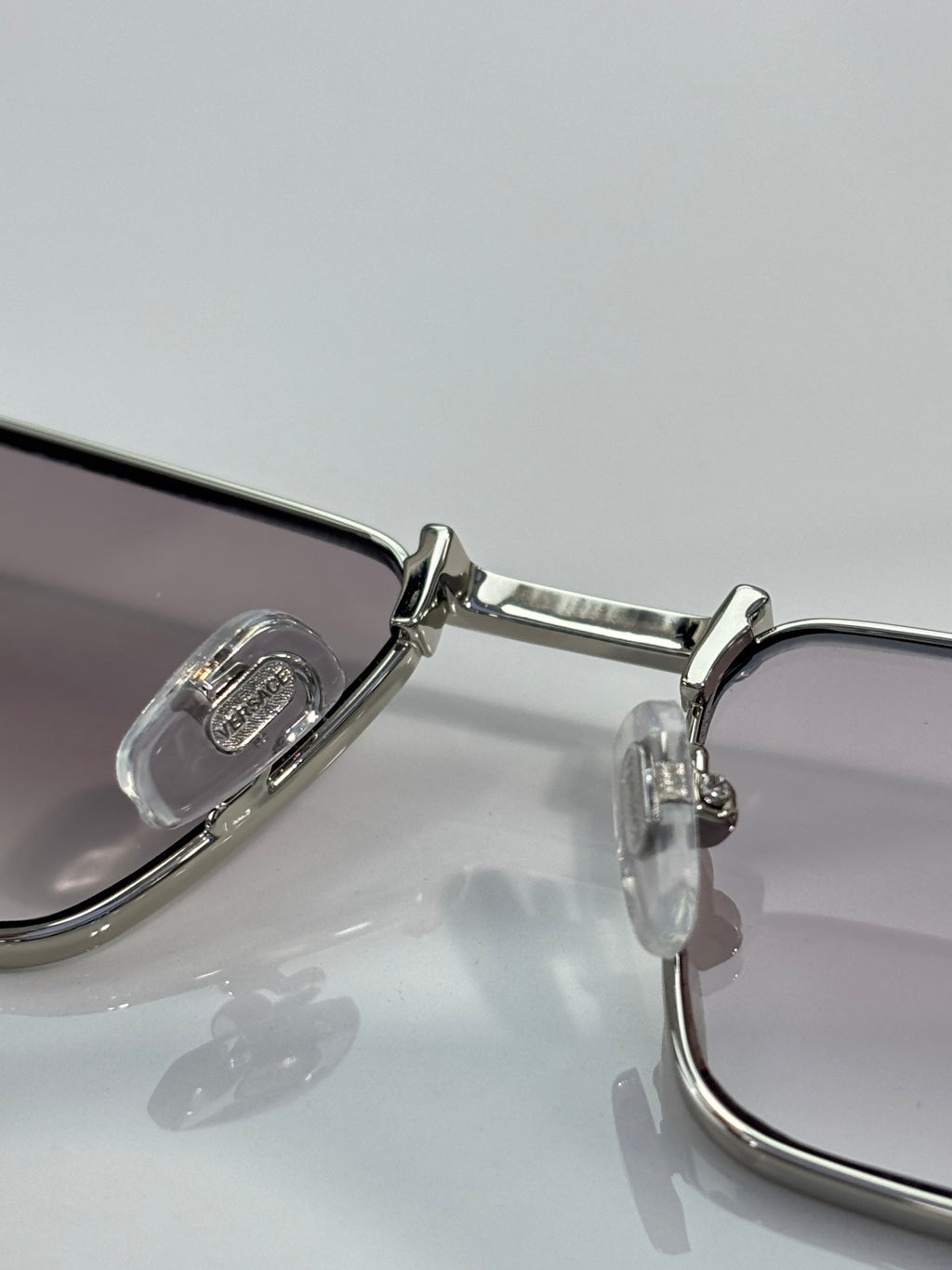 Versace sunglasses metal hinge and temple close-up with clear lens halves