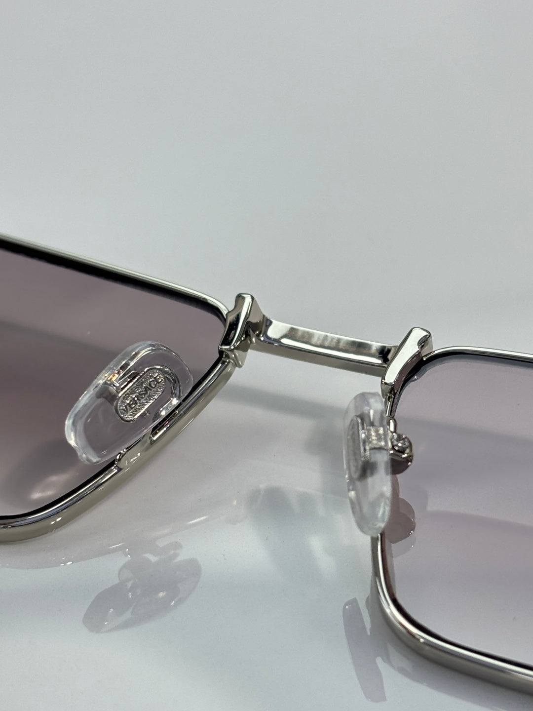Versace sunglasses metal hinge and temple close-up with clear lens halves