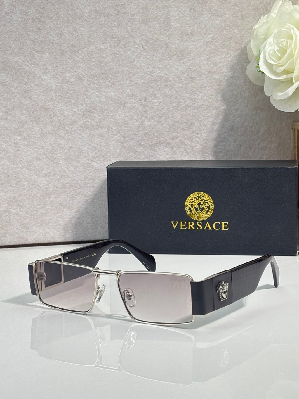 Versace rectangular sunglasses with light-tone frame and dark lenses, gold-tone logo details
