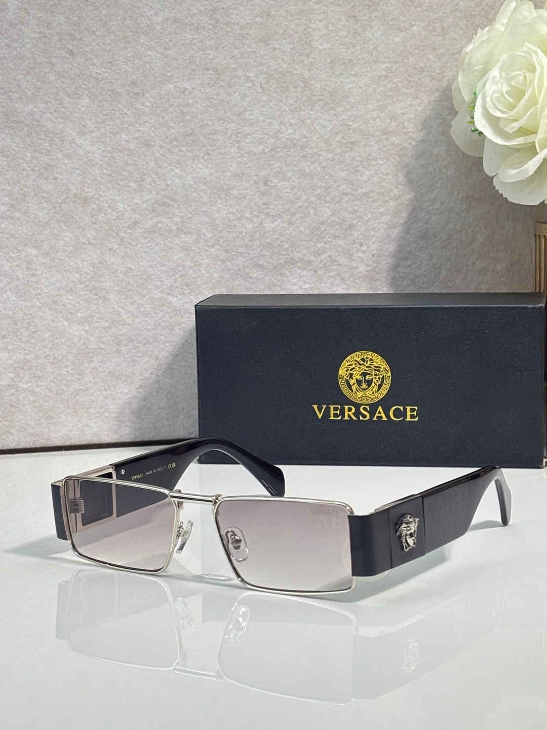Versace rectangular sunglasses with light-tone frame and dark lenses, gold-tone logo details