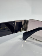 Versace sunglasses temple and lens close-up, silver metal with dark blue frame