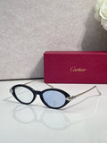 Black oval glasses with gold temples and dark tinted lenses