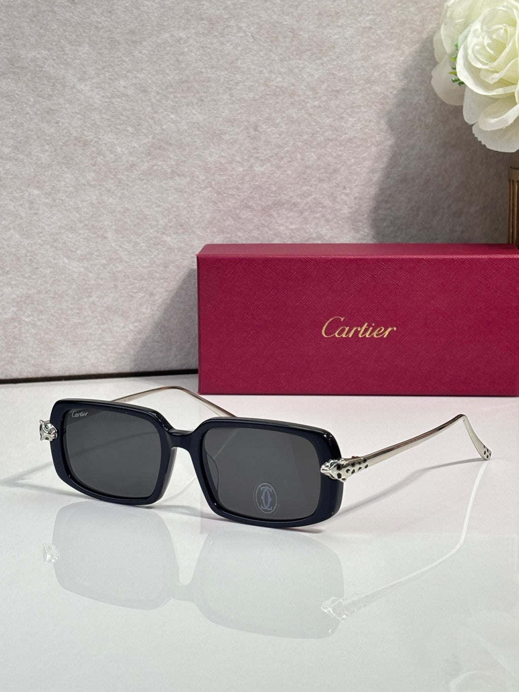 Cartier eyeglasses with dark frame and gold-tone temples, dark tinted lenses