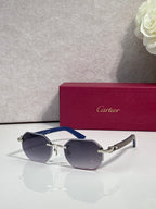 Cartier round eyeglasses with dark blue lenses, navy temples, and silver metal frame