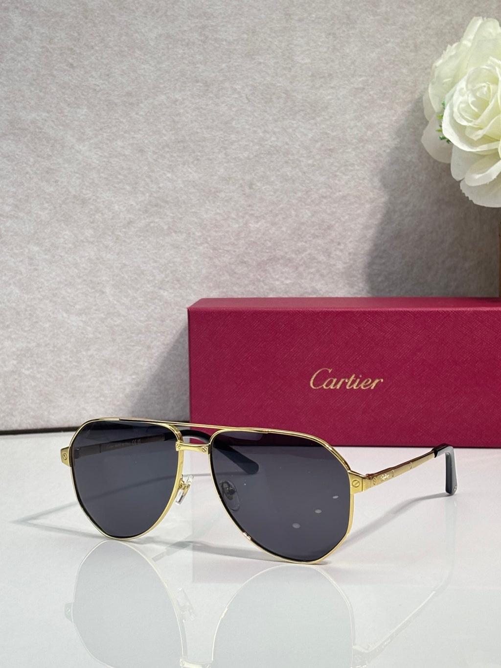 Metal sunglasses with dark lenses, gold frame and thin metal arms