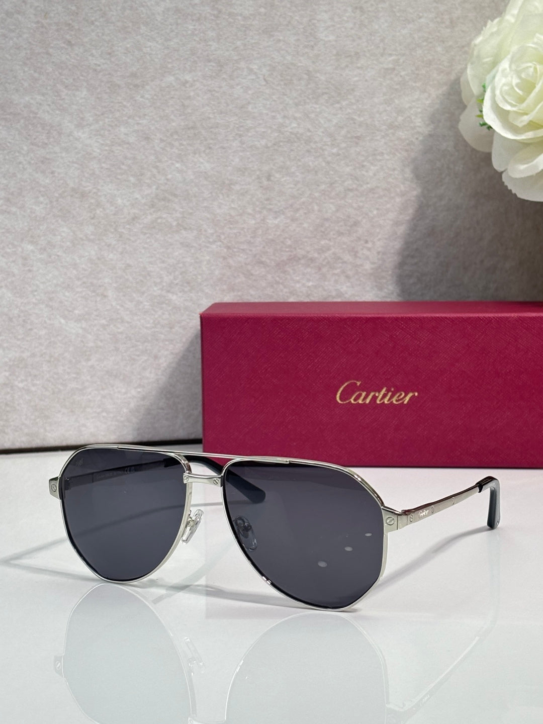 Metal sunglasses with dark lenses, black frame and silver bridge