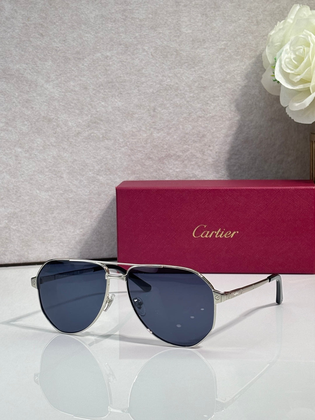 Metal sunglasses with navy-tinted lenses, black frame and silver arms