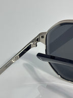 Cartier sunglasses side view: silver metal frame with dark lens and hinge