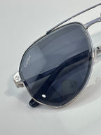 Cartier sunglasses close-up with dark navy-tinted lenses on silver metal frame