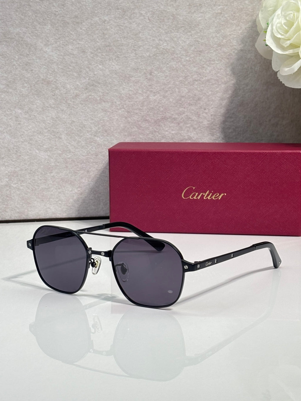 Black-tinted round sunglasses with silver-tone metal frame and dark lenses
