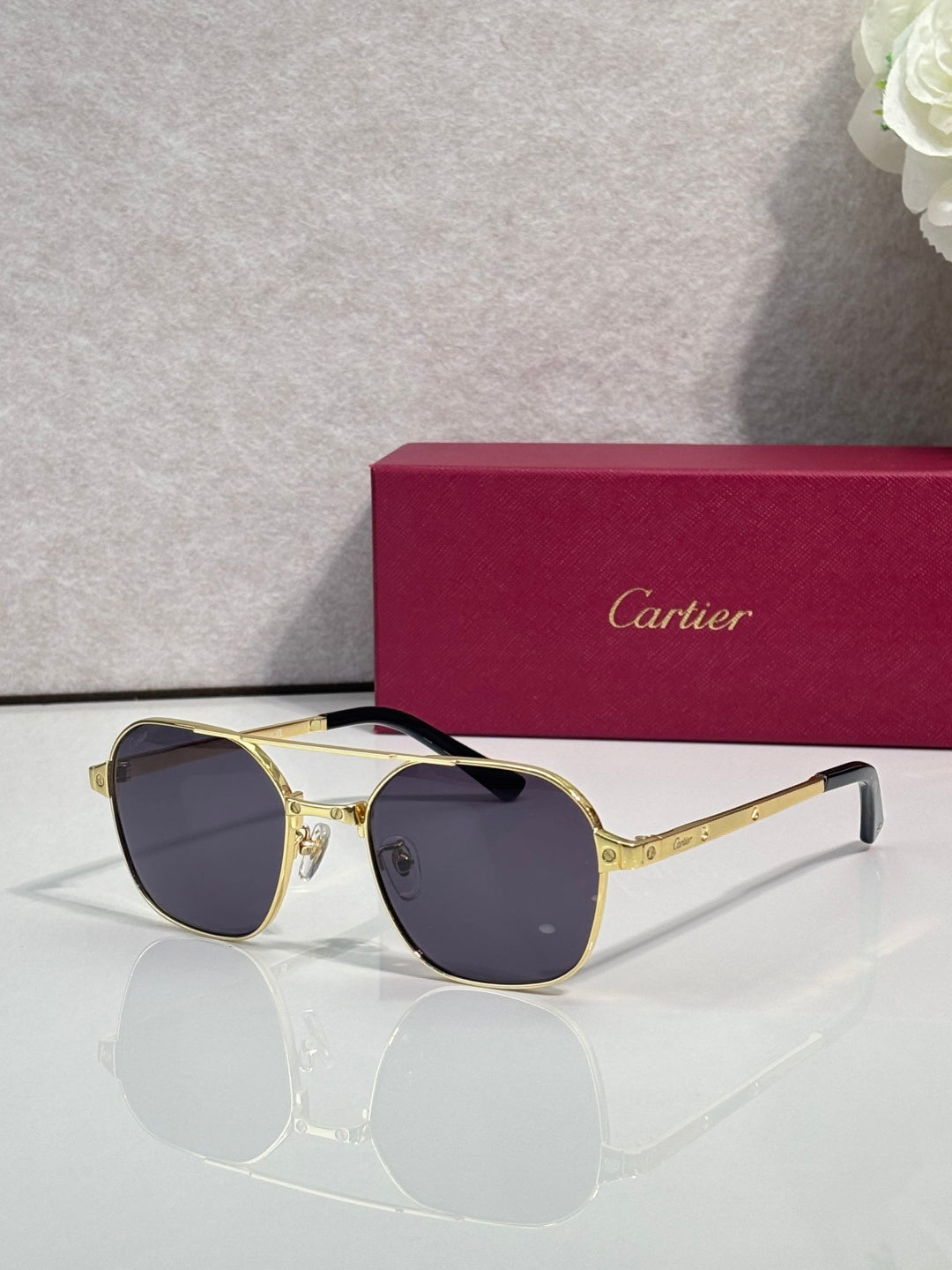 Dark blue round sunglasses with gold-tone metal frame and tinted lenses