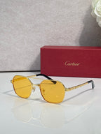 Amber-tinted round sunglasses with gold-tone metal frame and tinted lenses
