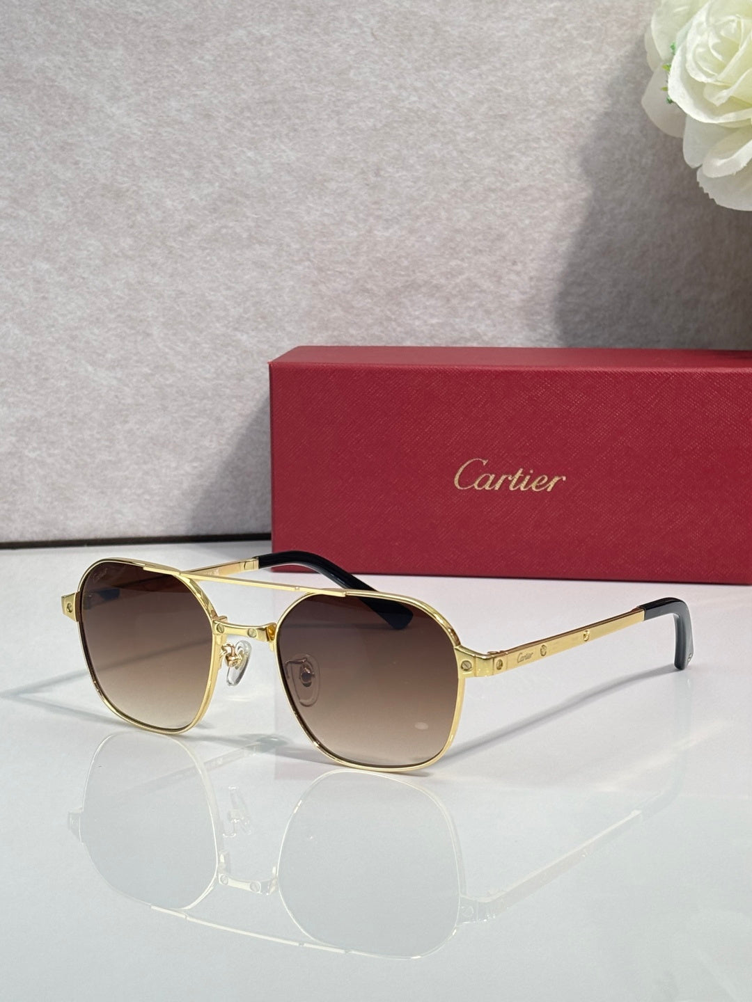 Amber-tinted round sunglasses with gold-tone metal frame and light lenses