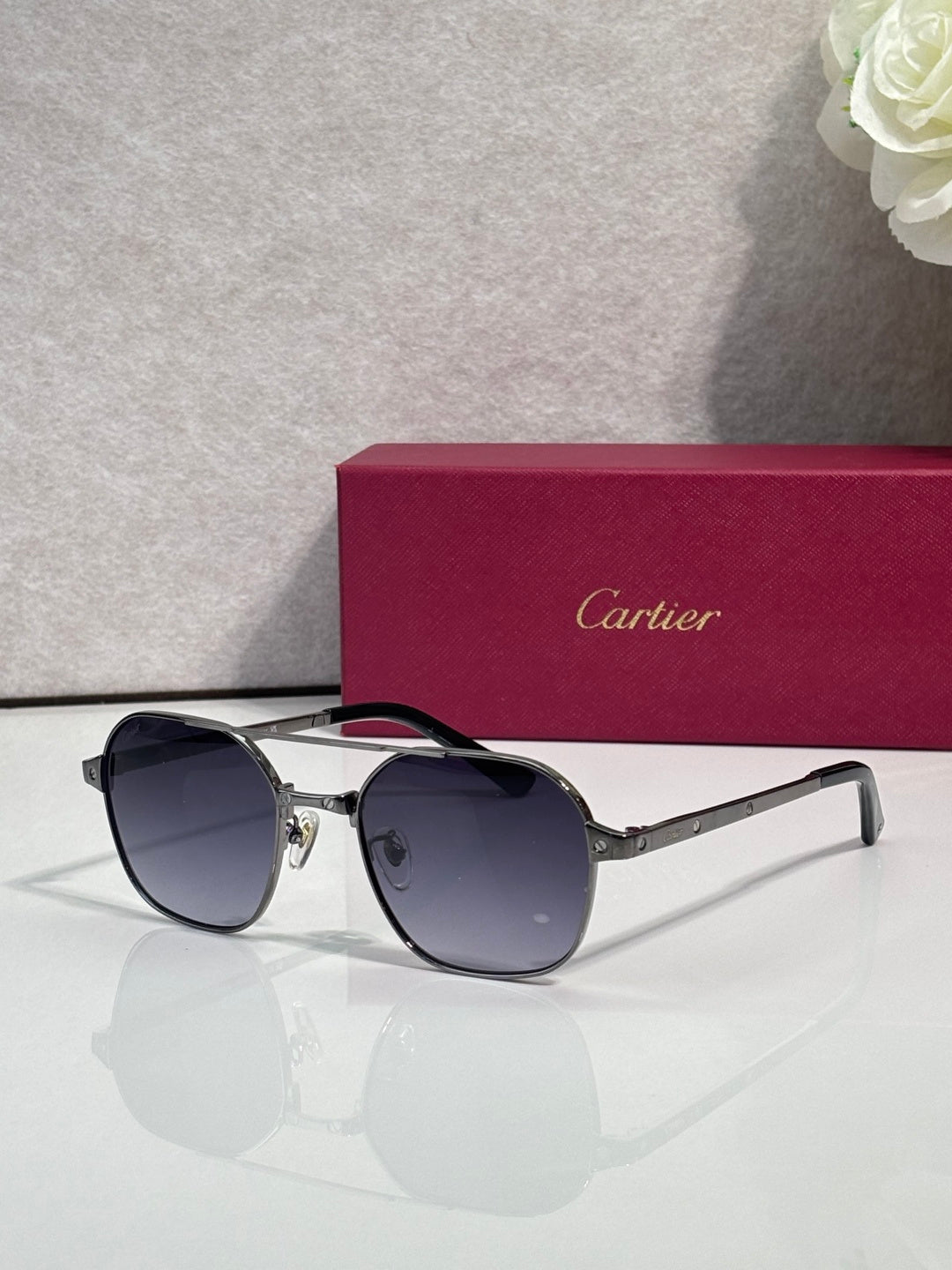Blue-tinted round sunglasses with silver-tone metal frame and dark lenses