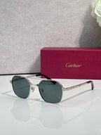 Green-tinted round sunglasses with gold-tone metal frame and dark lenses