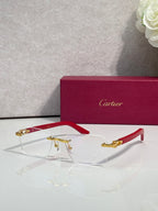 Eyeglasses with clear lenses, gold metal frame, red arms and gold-toned details