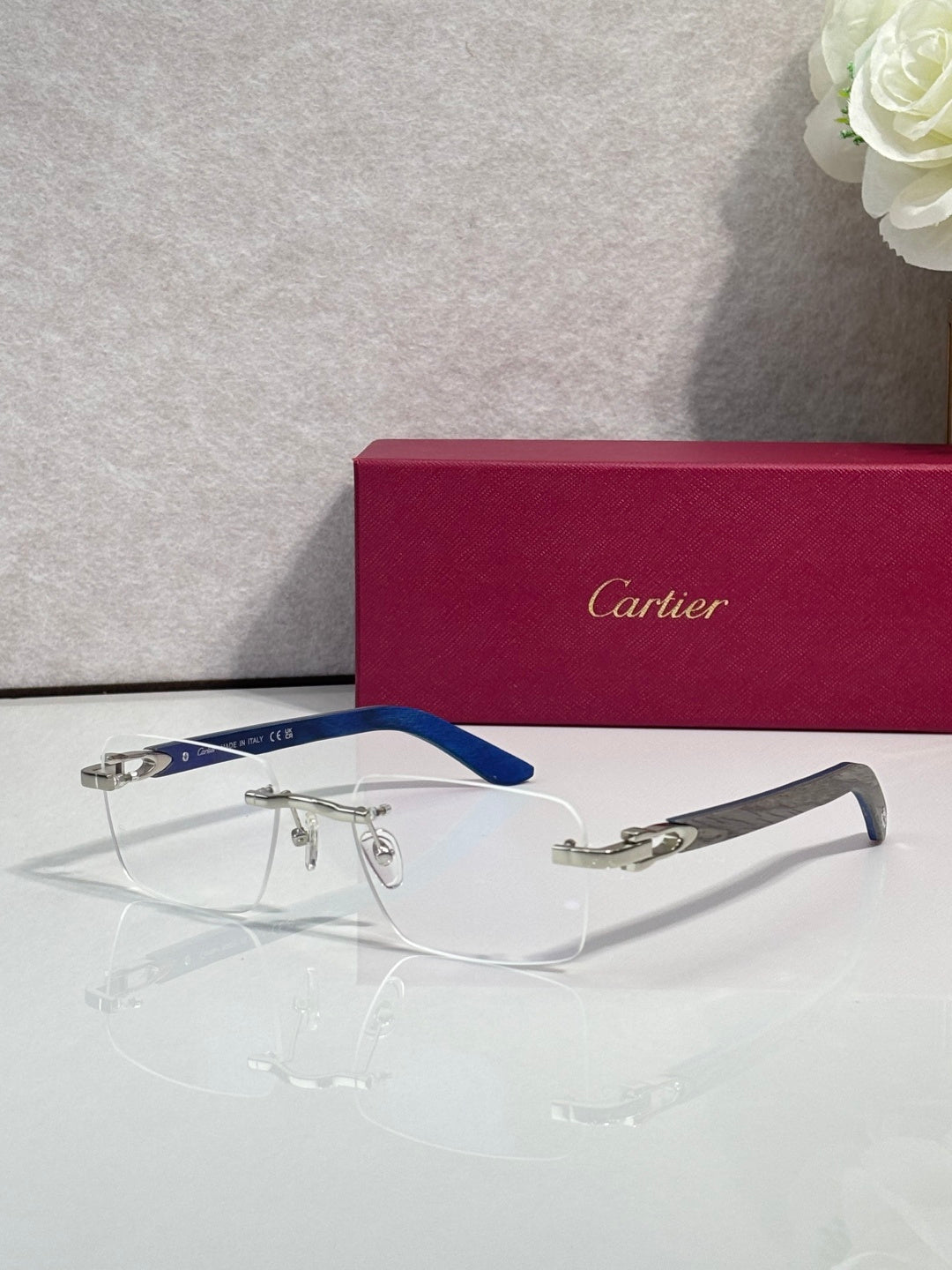 Eyeglasses with clear lenses, silver frame, blue arms and gold-toned accents