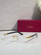 Eyeglasses with clear lenses, gold metal frame, dark arms and gold-toned accents
