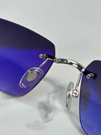 Cartier glasses close-up, blue-tinted lens with metal frame and hinge detail