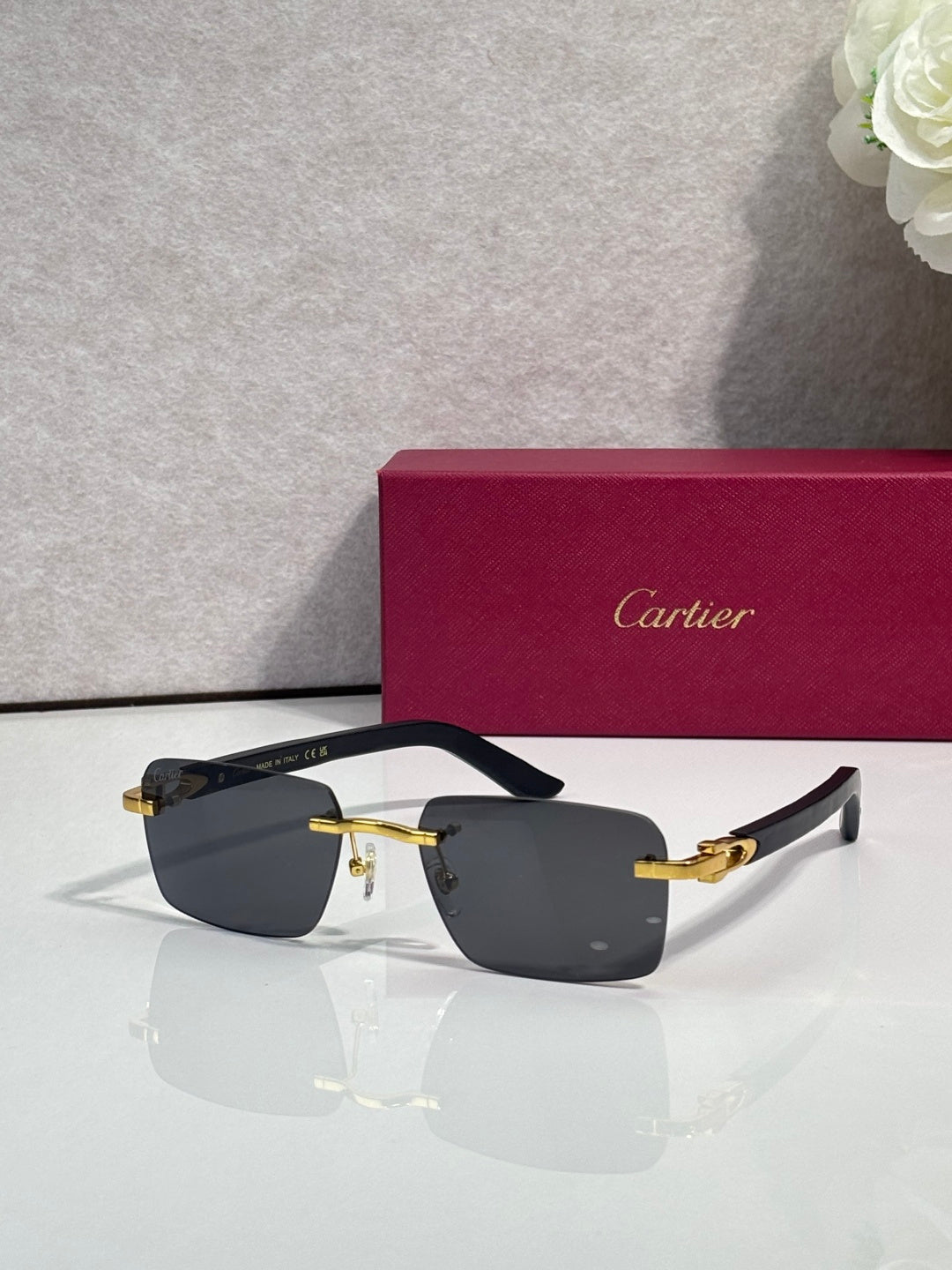 Cartier glasses, black frame with gold-tone hinges and gray-tinted lenses
