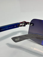 Cartier glasses close-up, engraved temple with blue-tinted lens and metal frame