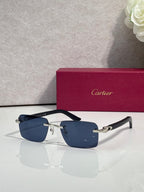 Cartier sunglasses with dark blue frames, blue gradient lenses, and gold metal accents