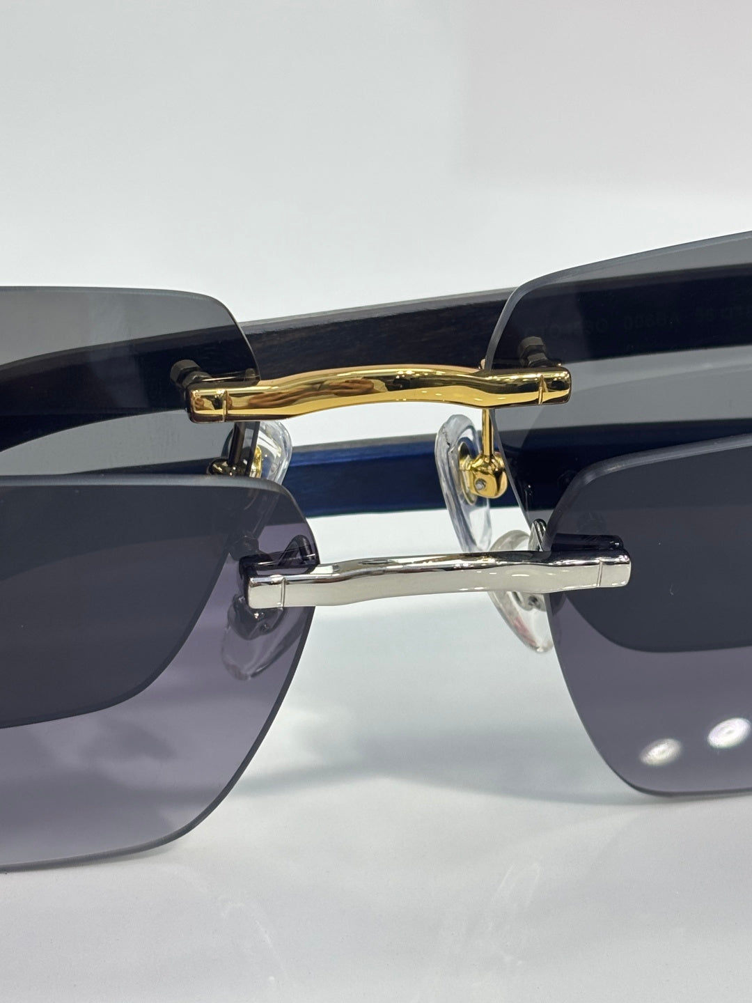 Cartier sunglasses front close-up with gold bar hinge and blue gradient lenses