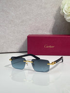 Cartier sunglasses with black frames, blue gradient lenses, and gold metal accents