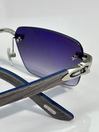 Cartier sunglasses close-up of dark blue lenses and silver hardware on the arm