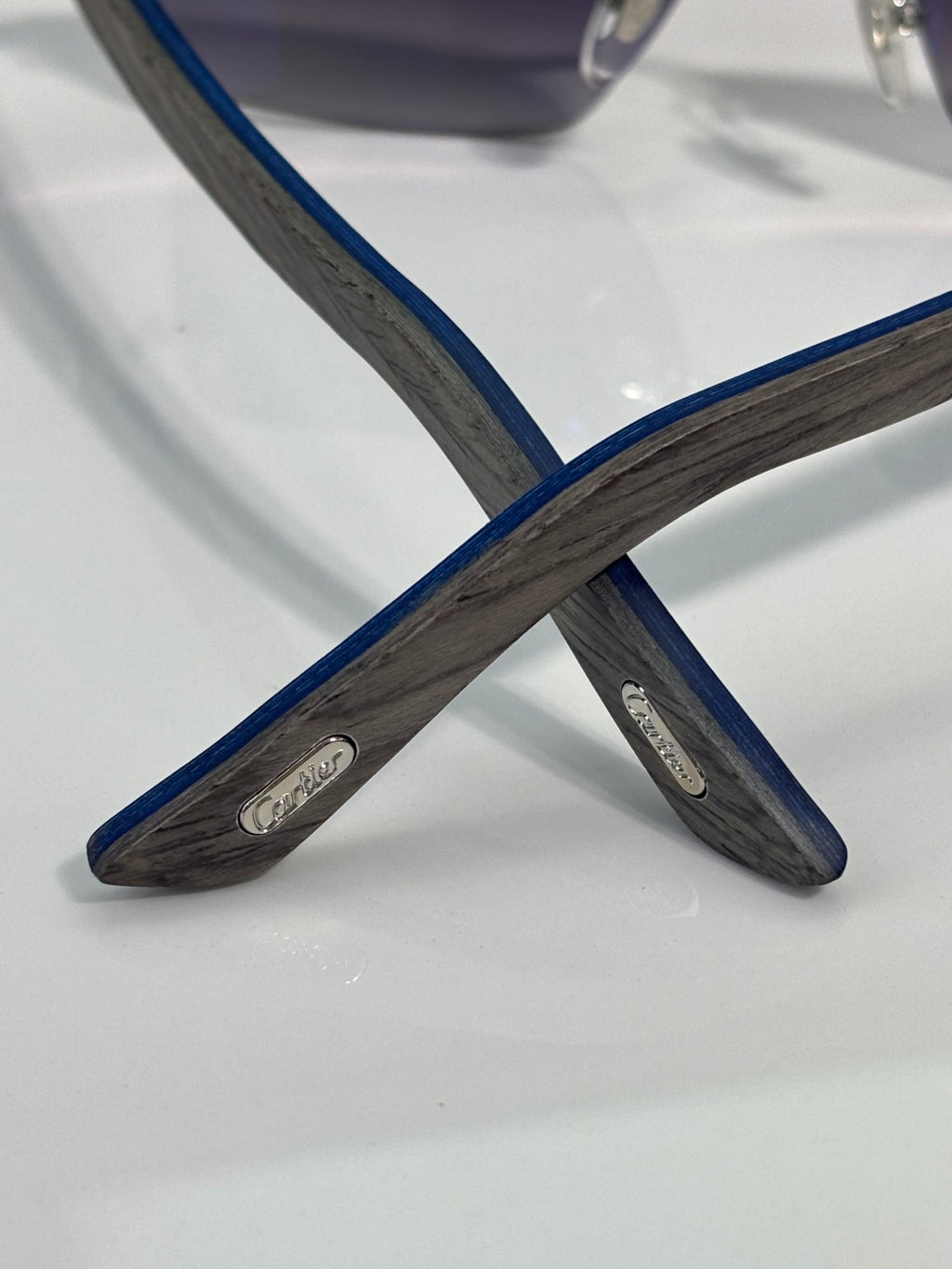 Cartier sunglasses arm view with dark blue and gray patterned temples