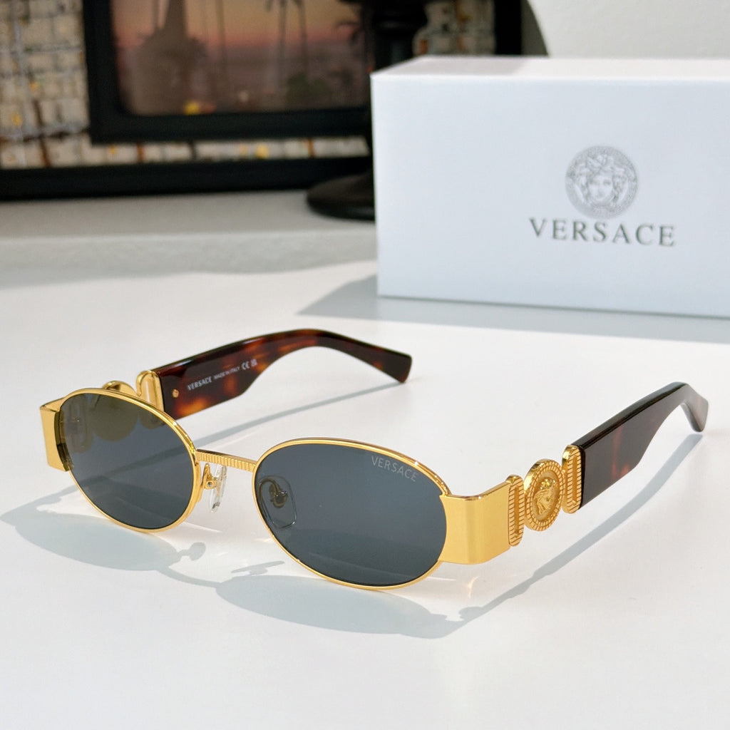 Versace sunglasses: gold frame, smoky lenses, black temple details.