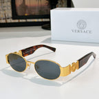 Versace sunglasses: gold frame, smoky lenses, black temple details.